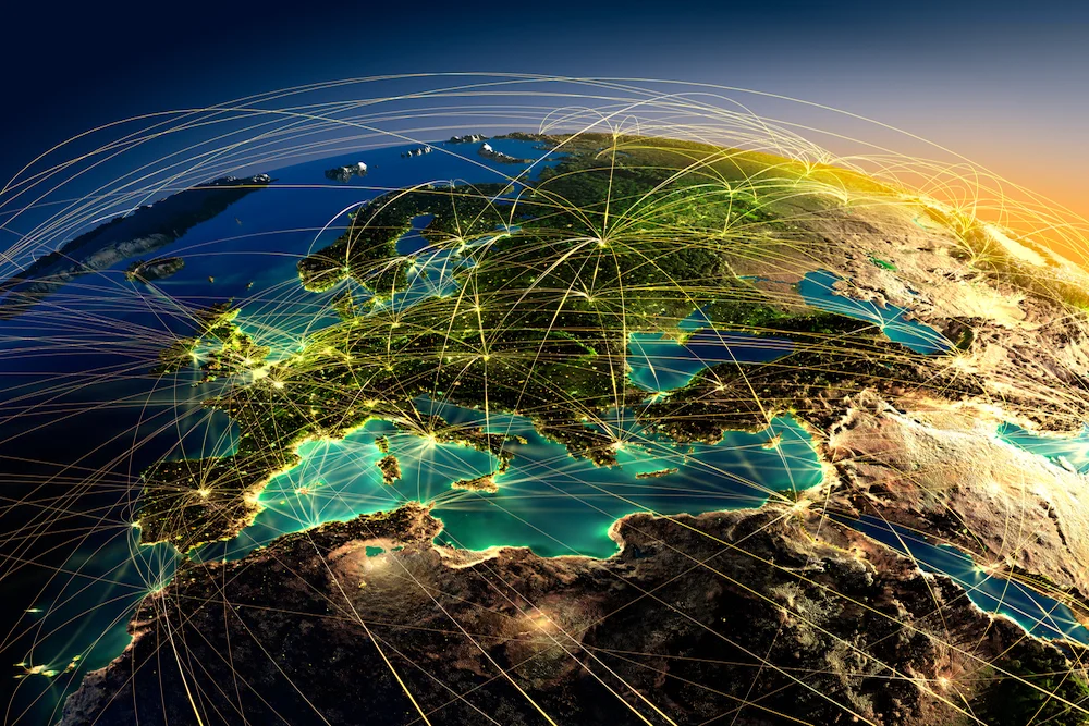 Illustrated graphic of Earth from space with glowing network lines over a continent on a dark blue background symbolising supply chain reach